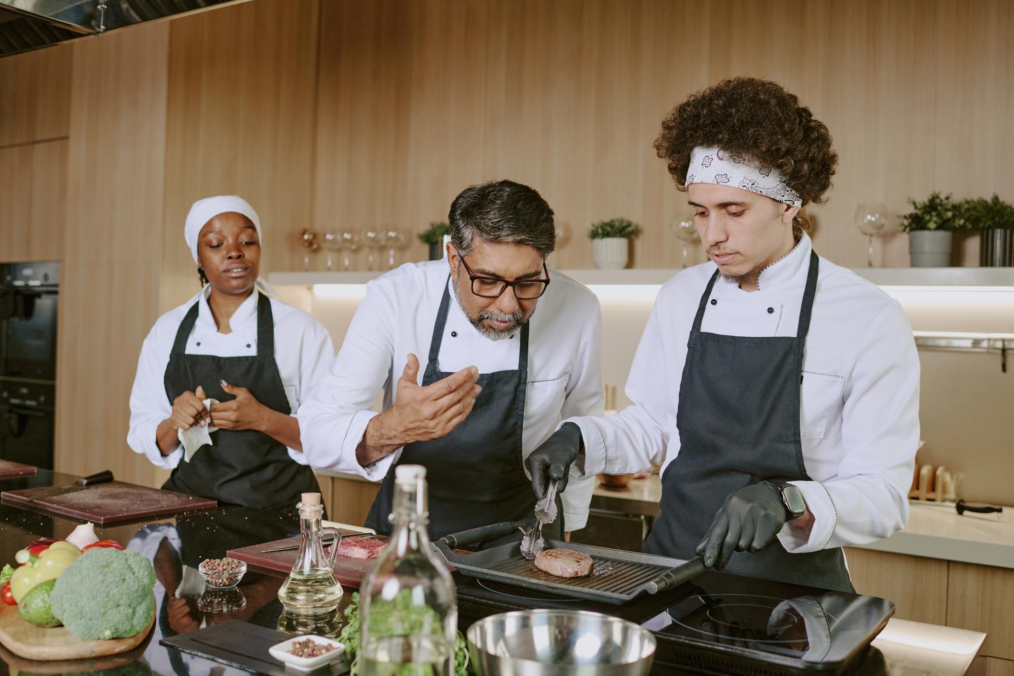 Workshop chef demonstrating technique to small group